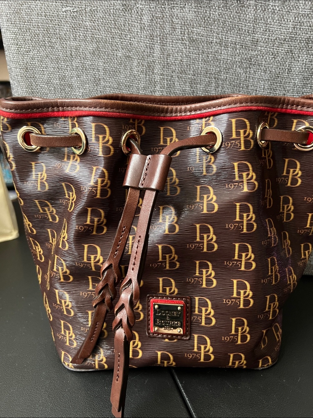 Dooney & Bourke Brown and Red Monogram Drawstring Bucket Bag